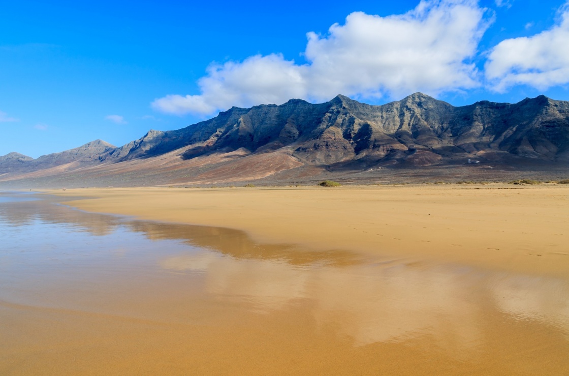 'Reflection of mountains in wet sand on Cofete beach in secluded part of Fuerteventura, Canary Islands, Spain' - Canary Islands