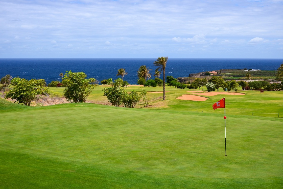 Flag on green grass in golf course of Buenavista del Norte, Tenerife, Canary Islands